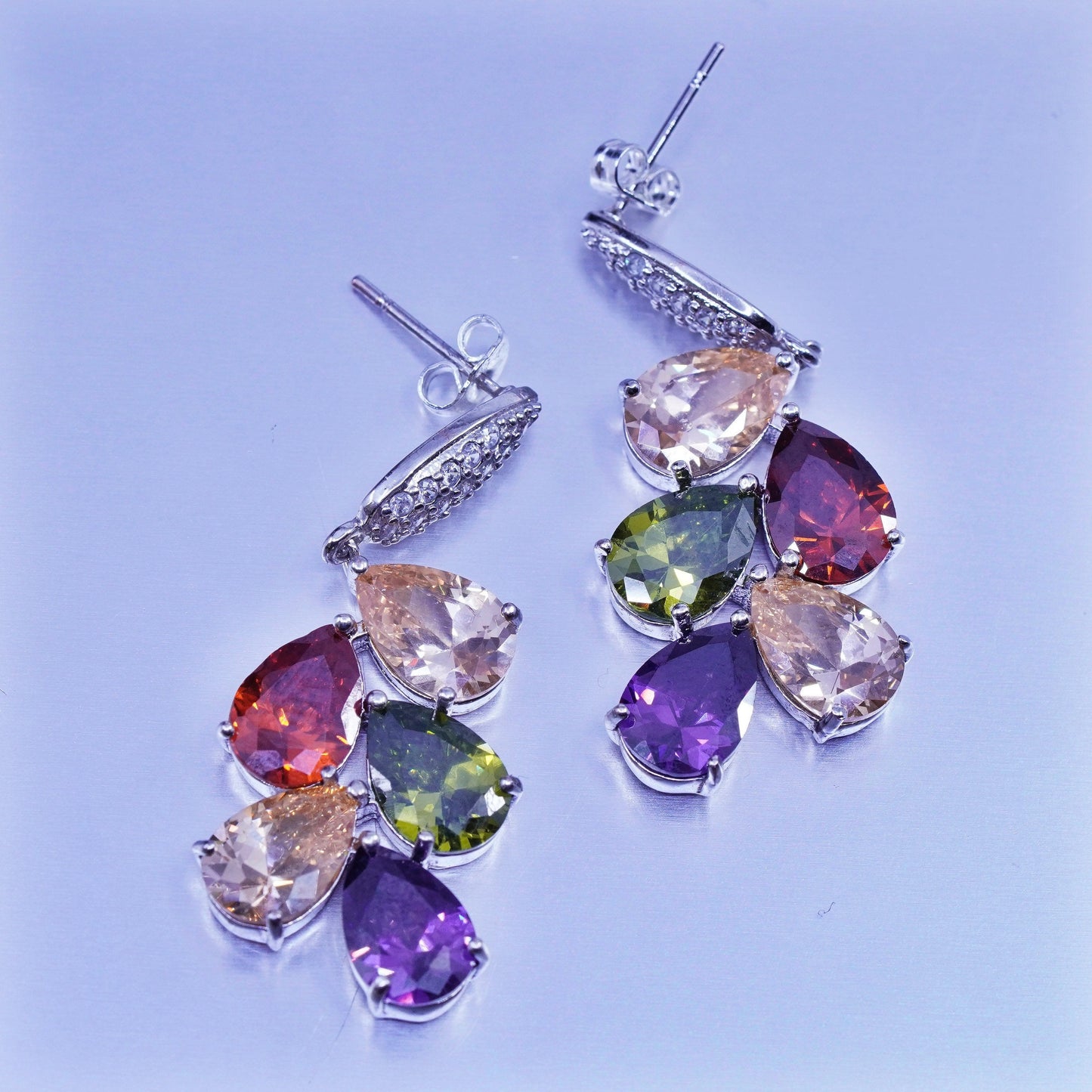 Silver tone earrings with teardrop colored cz
