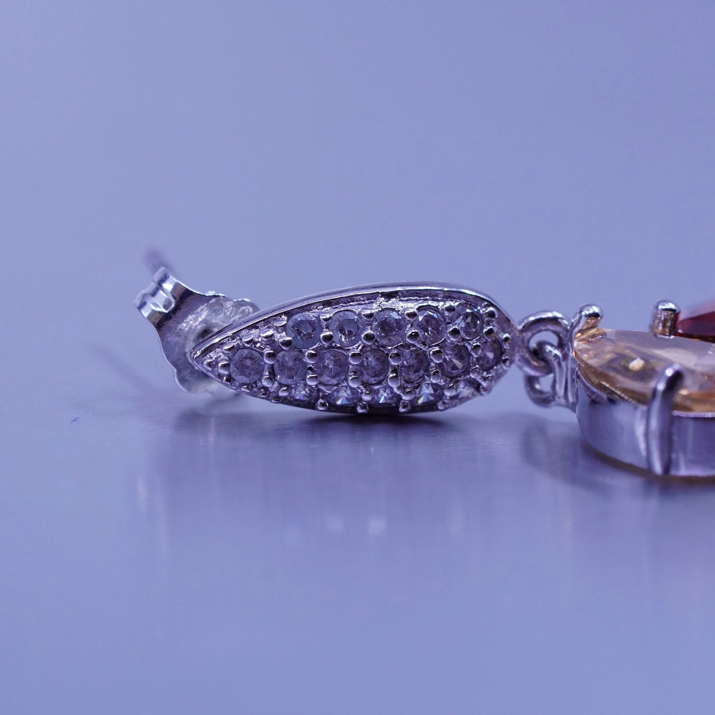 Silver tone earrings with teardrop colored cz