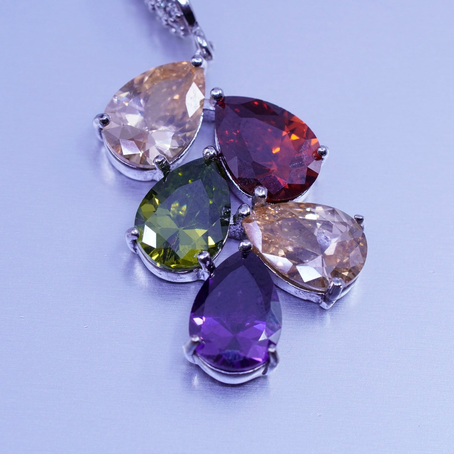 Silver tone earrings with teardrop colored cz