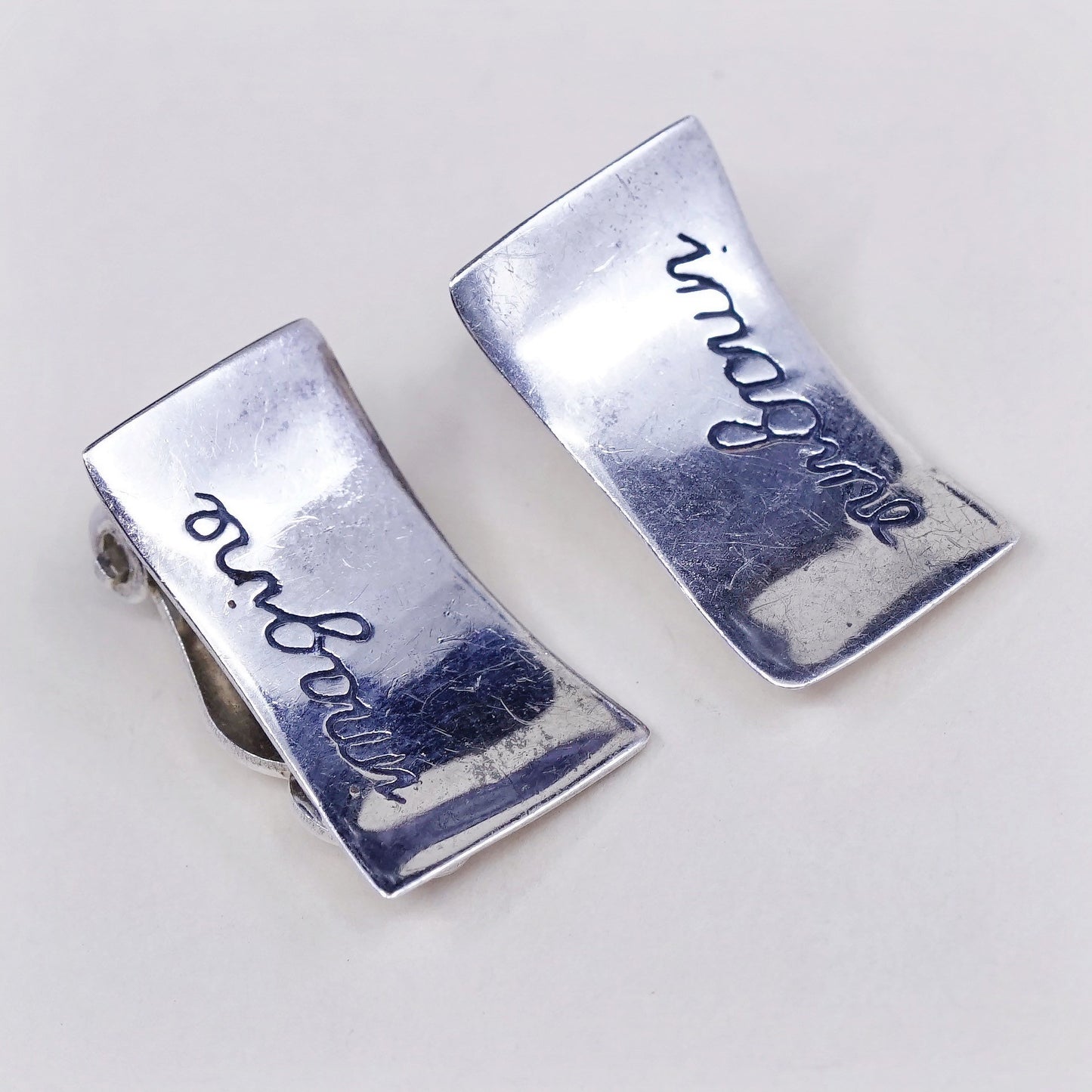 vtg Modern Sterling silver clip on, 925 inspiration earrings embossed “imagine”