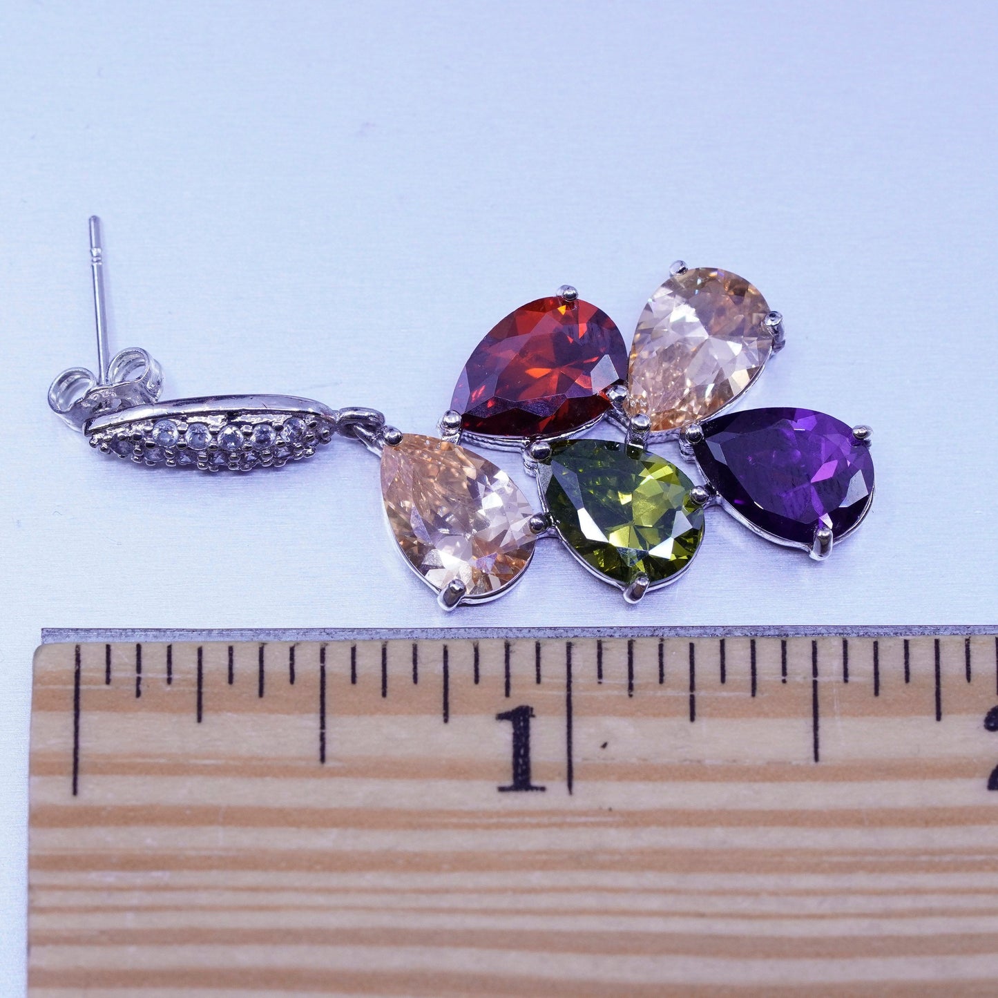 Silver tone earrings with teardrop colored cz