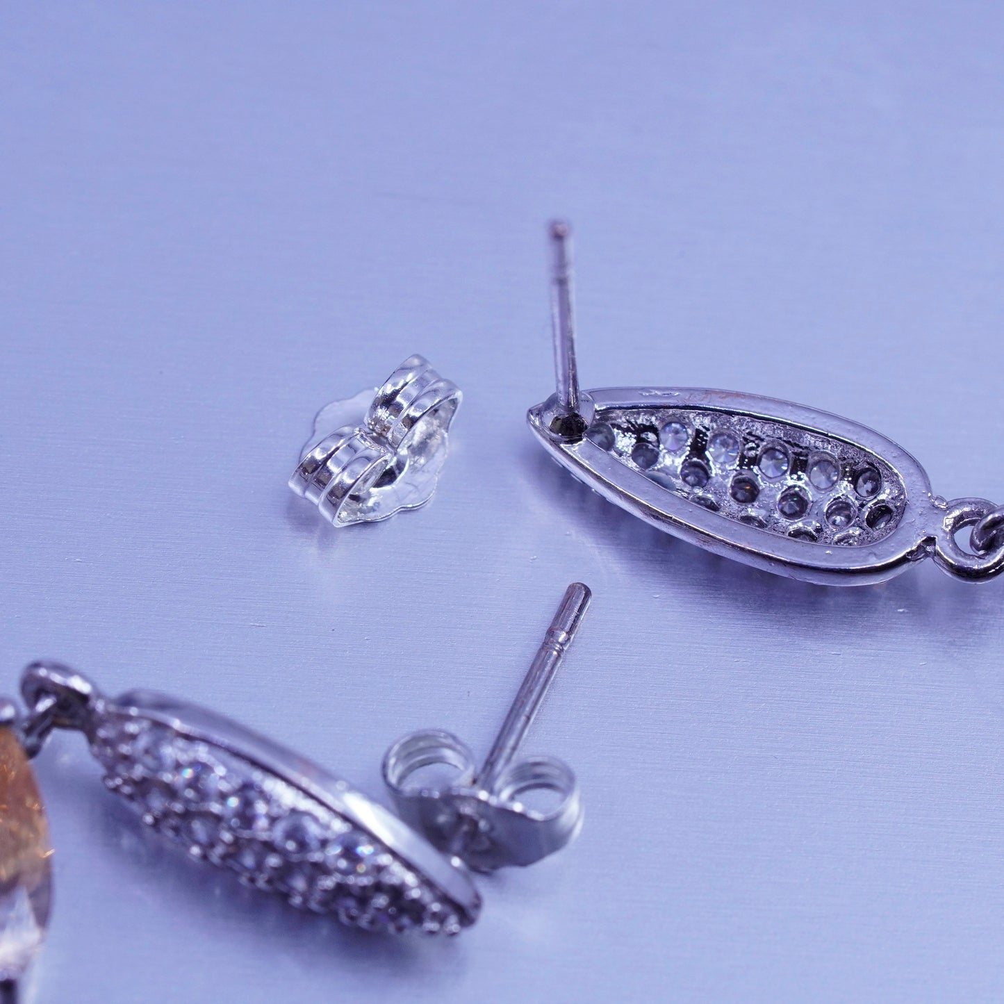 Silver tone earrings with teardrop colored cz