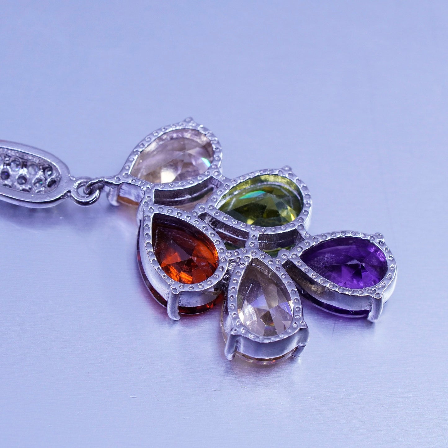 Silver tone earrings with teardrop colored cz