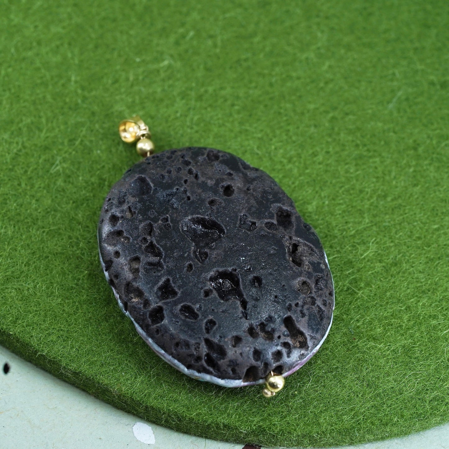 Vintage 14K yellow gold pendant with resin covered volcanic rock, lava rock