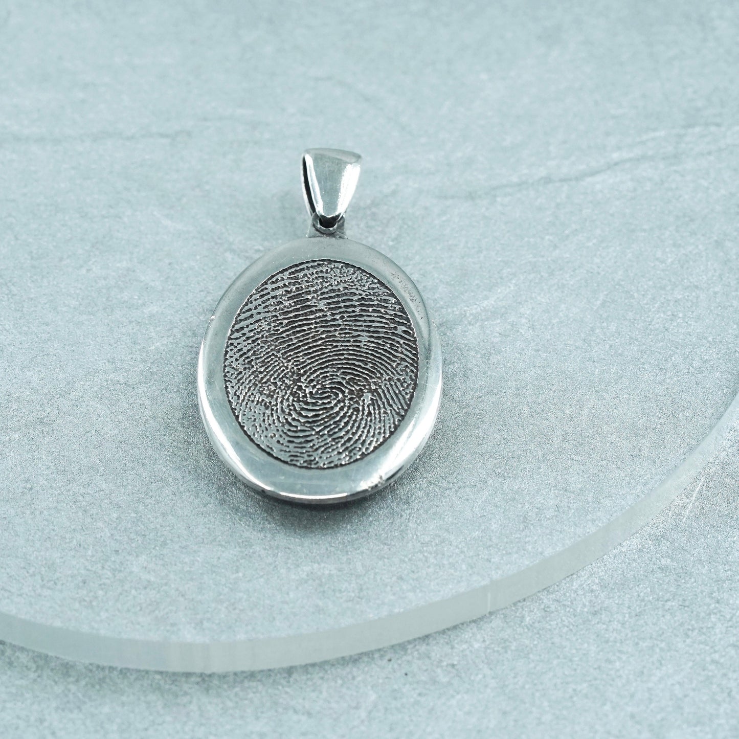 vintage sterling 925 silver pendant with oval fingerprint embossed “1977-2011”