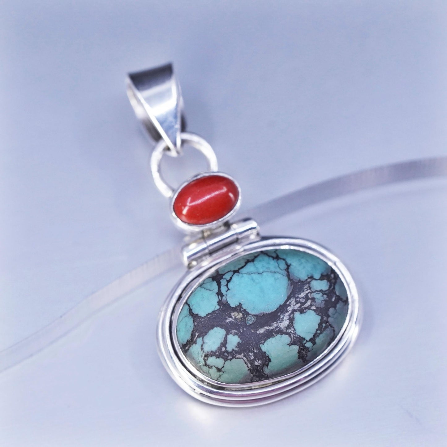 Native American sterling 925 silver pendant with spiderwebbed turquoise coral