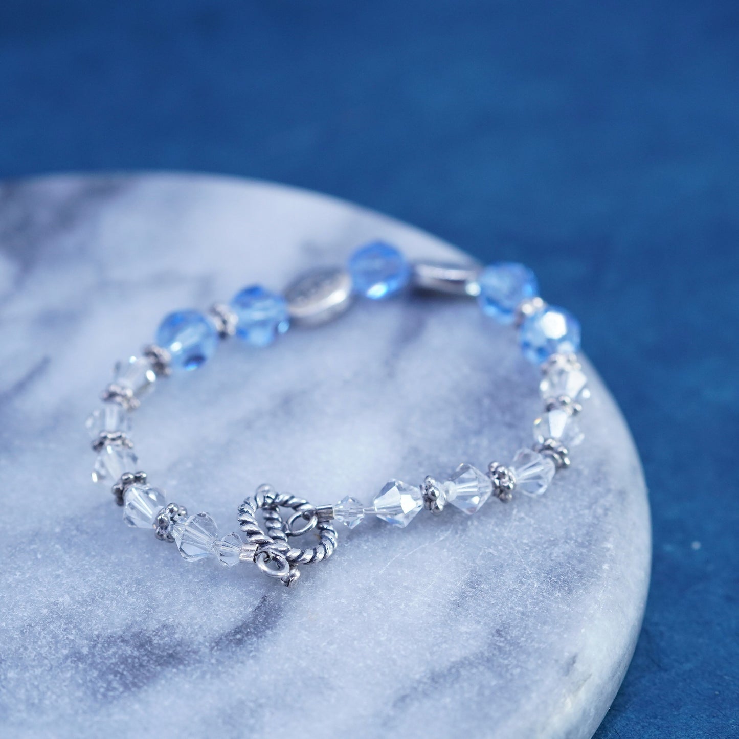 6.75”, Sterling 925 silver bracelet with blue crystal and believe god charms
