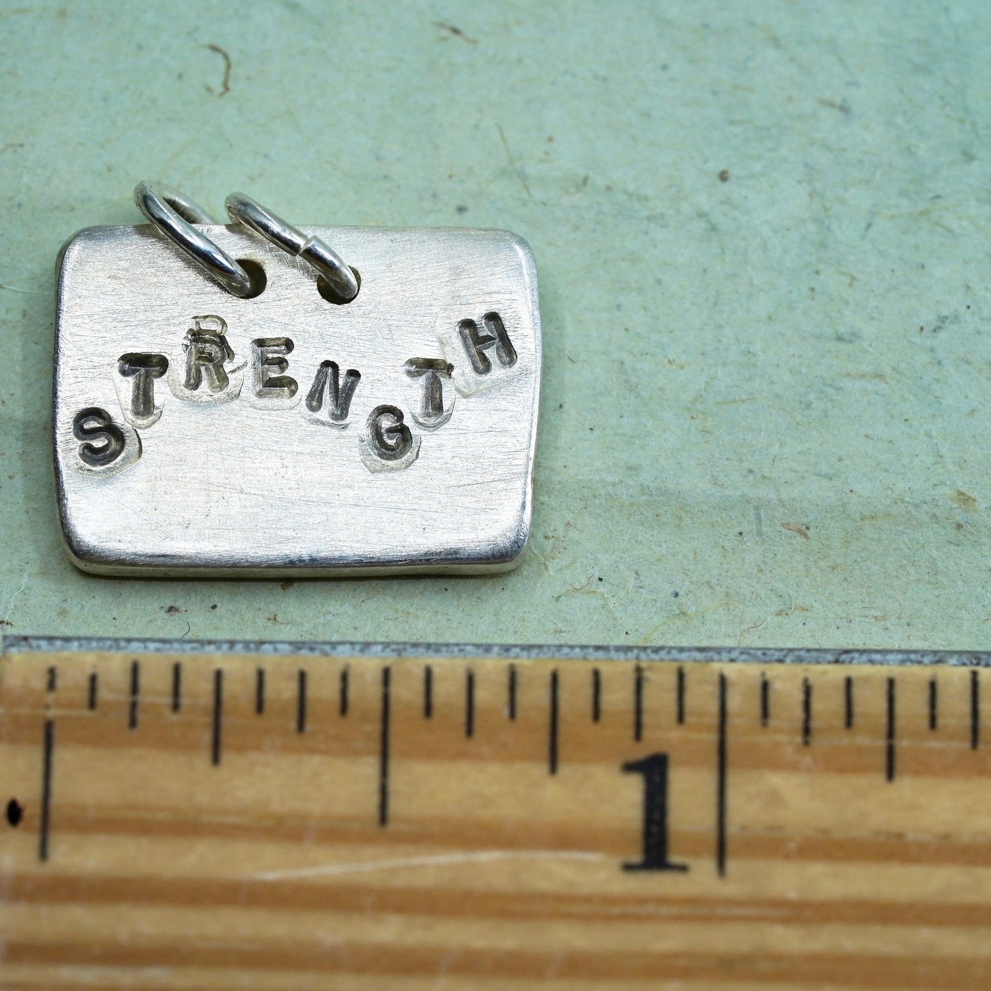 sterling silver pendant, 925 rectangular tag charm embossed “strength faith"