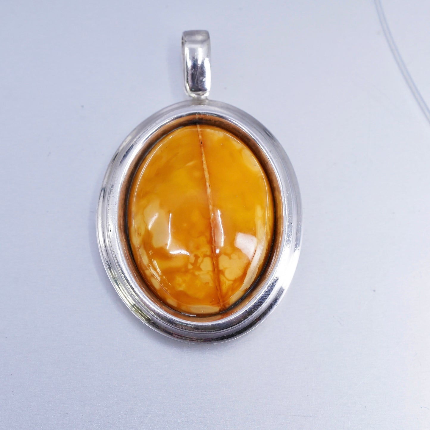 Vintage sterling 925 silver handmade pendant with oval amber