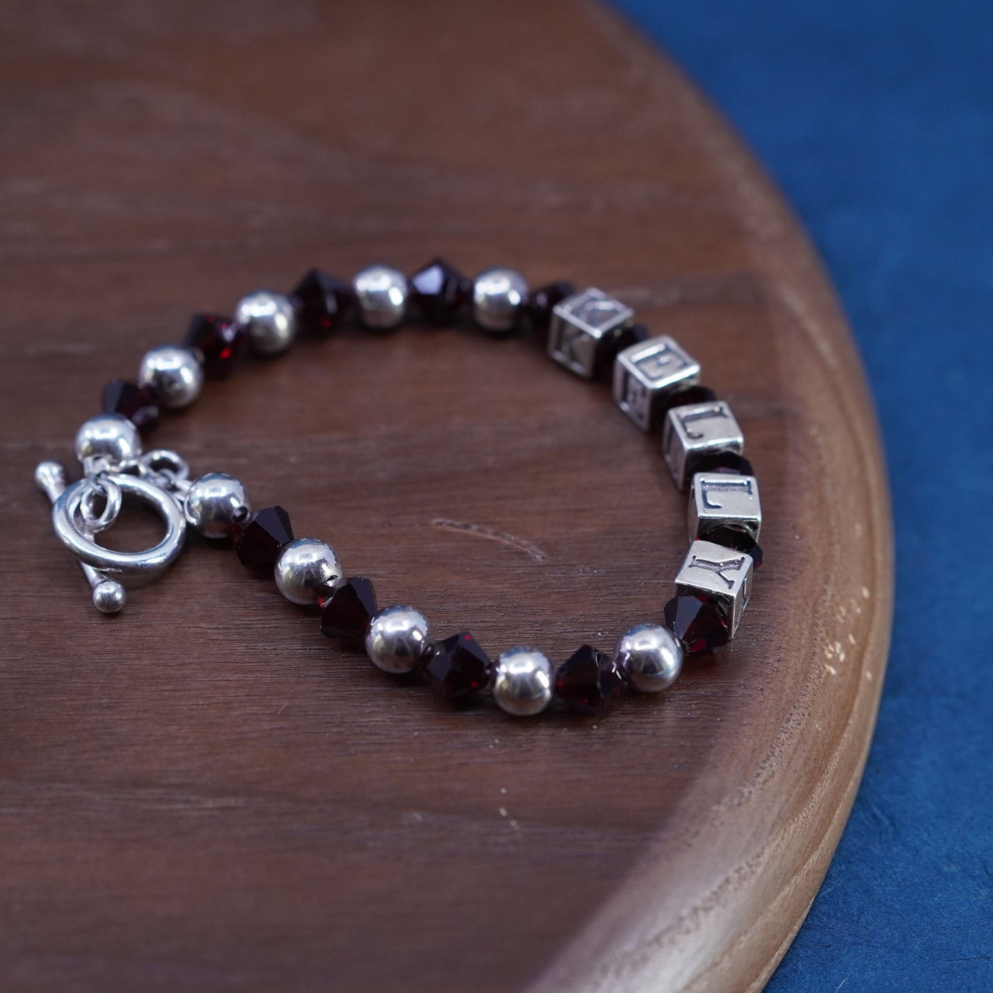 6.25”, sterling silver 925 bracelet with garnet beads and name “Kelly” cubes