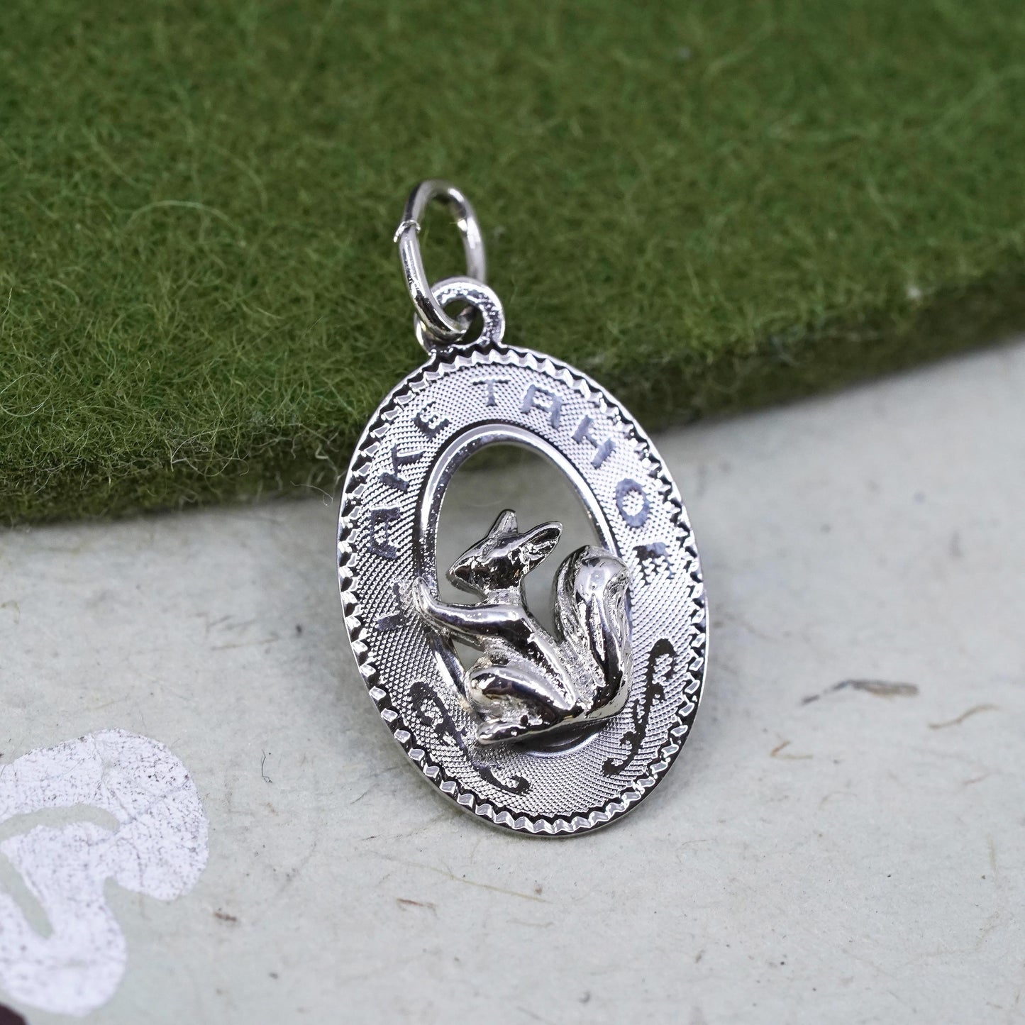 Vintage sterling silver 925 oval tag charm with squirrel embossed “Lake Tahoe”