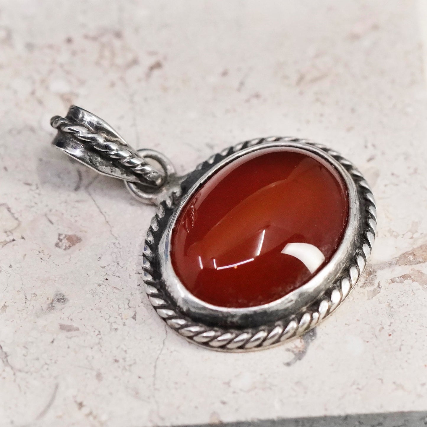 Vintage sterling silver handmade pendant with carnelian and cable around