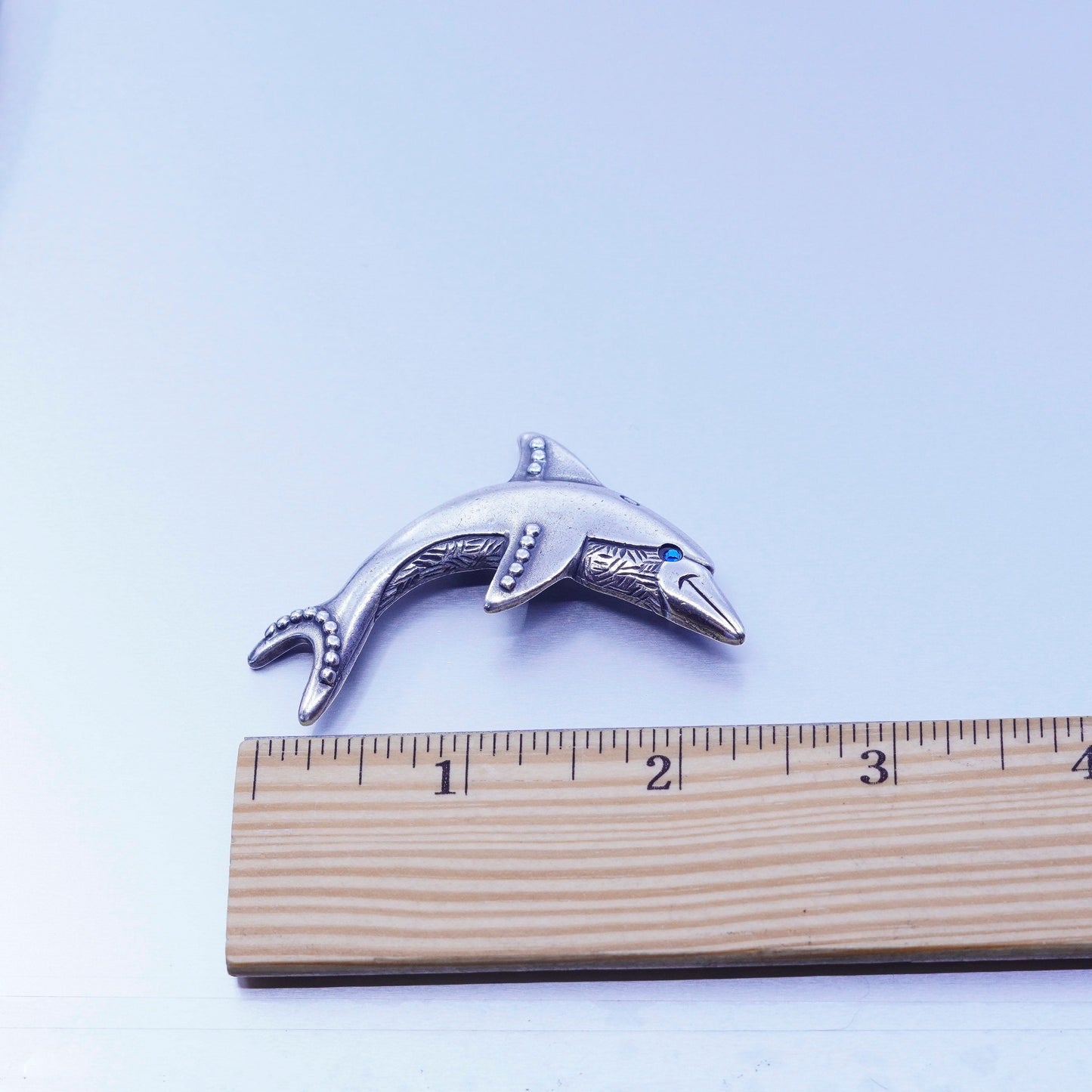 Vintage newpro silver tone dolphin brooch with blue eye