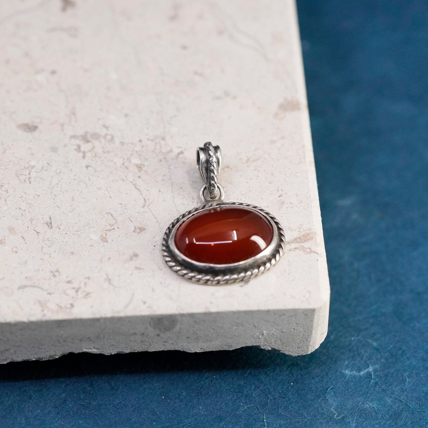 Vintage sterling silver handmade pendant with carnelian and cable around