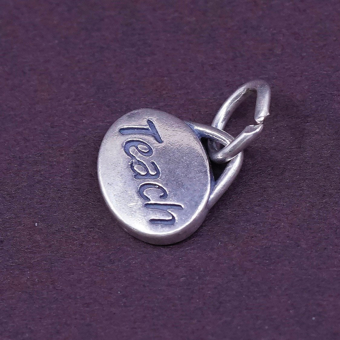 vtg SLC Sterling silver handmade charm, 925 tag pendant embossed “teach”