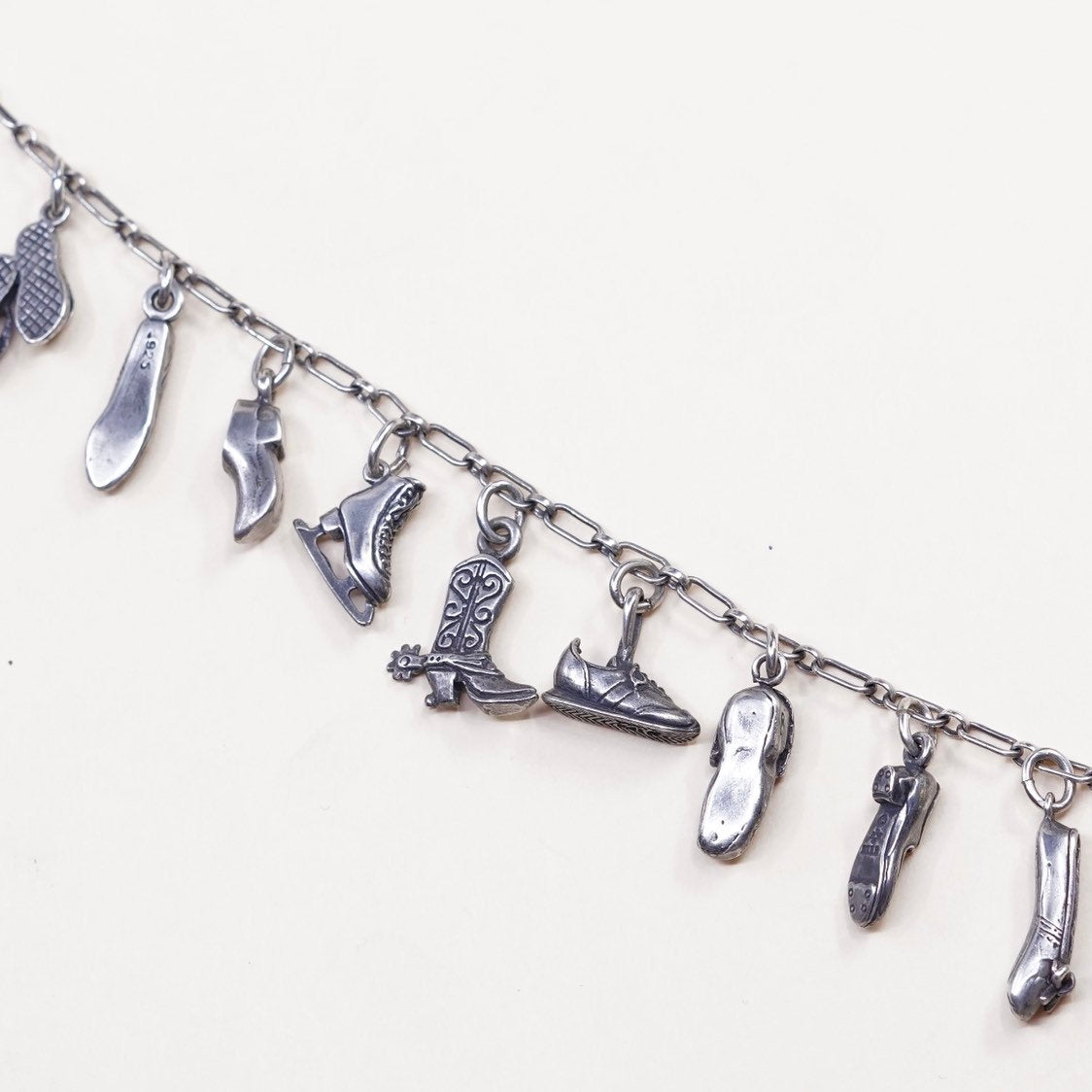 6.5”, beau sterling silver Handmade elongated chain bracelet w/ 11 shoe charms