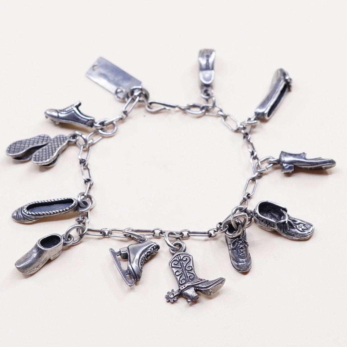 6.5”, beau sterling silver Handmade elongated chain bracelet w/ 11 shoe charms