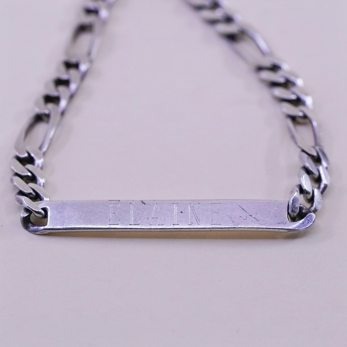 8” Sterling silver bracelet, 925 figaro chain name tag engraved “Elaine”