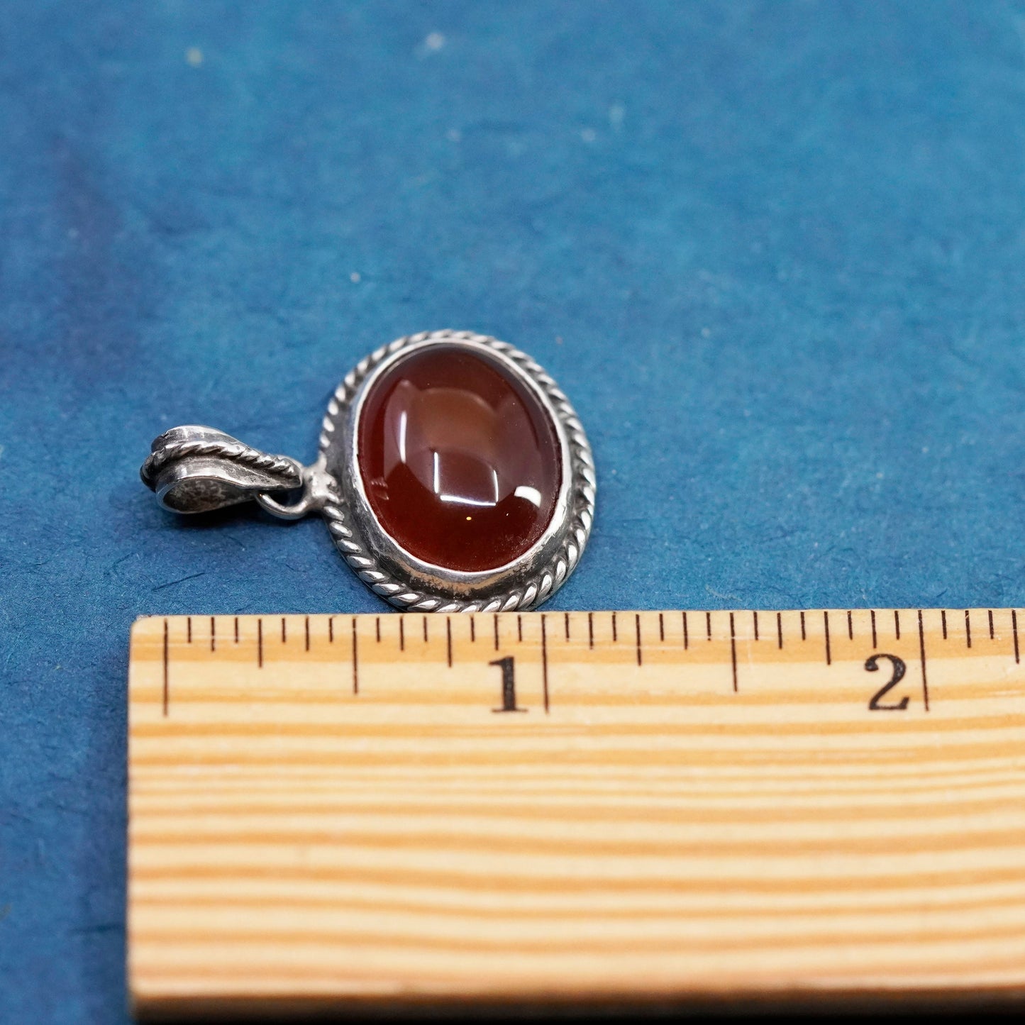 Vintage sterling silver handmade pendant with carnelian and cable around