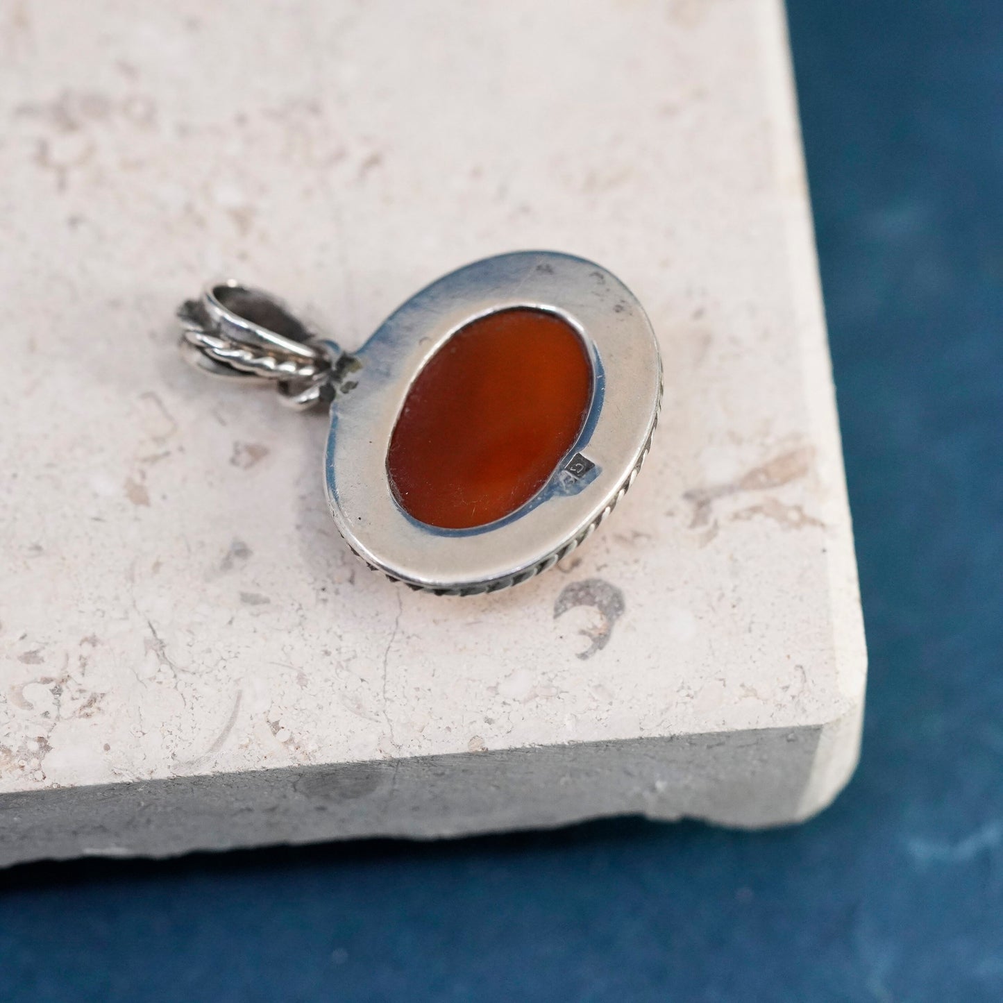 Vintage sterling silver handmade pendant with carnelian and cable around